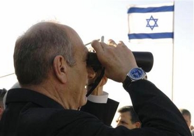 Israel's Prime Minister Ehud Olmert looks through a pair of binoculars during a meeting with former Gaza Strip settlers near Avshalom, in the Negev Desert, November 27, 2006 in this picture released by the Israeli Government Press Office (GPO).