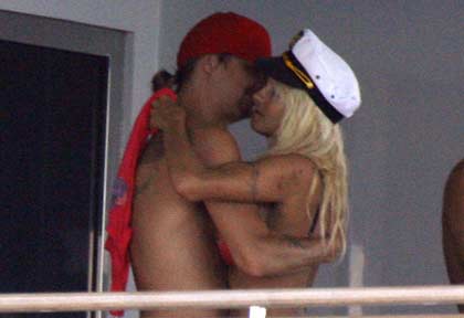 Canadian-born actress Pamela Anderson and rap singer Kid Rock of the U.S. embrace before their wedding ceremony aboard a yacht in St Tropez, southern France, in this July 29, 2006 file photo. Anderson has filed for divorce from Rock after four months of marriage, a pair of celebrity magazines reported on November 27, 2006. 