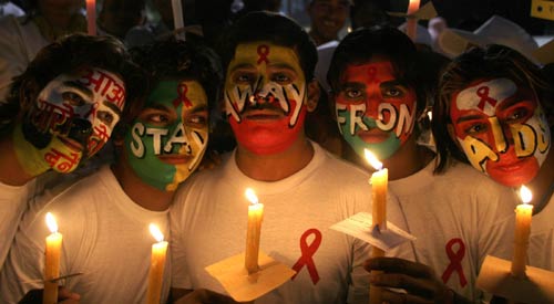 Volunteers pose during a candlelight procession on the eve of World AIDS Day in the northern Indian city of Chandigarh November 30, 2006. India has the largest number of people living with HIV/AIDS at 5.7 million, according to UNAIDS, and 85 percent of infections are transmitted through sex. 