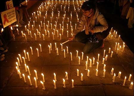 An Indian activist from NGO's working in the HIV/AIDS sector lights candles during a vigil in New Delhi. UN chief Kofi Annan urged greater accountability in the global battle against AIDS on the eve of World AIDS Day