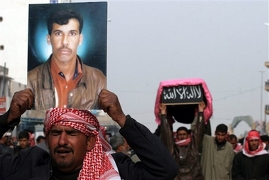 Friends and relatives take part in the funeral procession carrying the coffin and a portrait of Malik Hussein, in Najaf, south of Baghdad, Iraq, Wednesday, Dec. 6, 2006. Malik Hussein, an Iraqi soldier, was killed by sniper fire on Baghdad's airport road on the previous day. (AP 