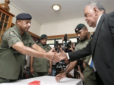 Fijian military Commodore Frank Bainimarama, left, shakes hands with Dr. Jona Senilagakali after he was sworn in as caretaker prime minister at a ceremony at the main military barracks in the capital, Suva Wednesday, Dec. 6, 2006. Earlier, Bainimarama ordered the state of emergency, saying a security cordon would immediately be set up around Suva, check points established at strategic points in the city, and that all military reserves would be 'marched into' military camps to support the regime. (AP 