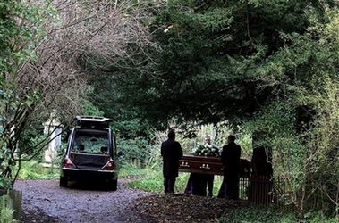 The coffin of former Russian spy Alexander Litvinenko is carried during his funeral at Highgate Cemetery in north London Thursday Dec. 7 2006. Billionaires, Kremlin critics and Chechen rebels gathered at a famous London cemetery to mourn ex-Russian spy Alexander Litvinenko, on Thursday, standing in a downpour as he was laid to rest in a dark oak casket. (AP Photo