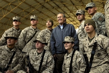 In this image released by the US Department of Defense, outgoing Secretary of Defense Donald Rumsfeld meets troops at Al-Assad air base in Iraq's volatile Anbar province Saturday Dec. 9, 2006, during a surprise visit to Iraq. Rumsfeld's trip follows an emotional farewell Friday at the Pentagon in Washington, where the defense secretary defended his record on Iraq and Afghanistan. (AP