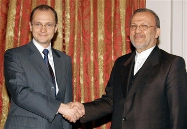 Russian Atomic Agency Chief Sergei Kiriyenko, left, shakes hands with Iranian Foreign Minister, Manouchehr Mottaki, during their meeting in Tehran, Iran, Monday, Dec. 11, 2006. Russia's nuclear chief will arrive in Tehran Monday for talks on finishing the construction of Iran's first nuclear power plant, being built by Russians in the south of the country. (AP 