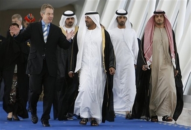 Britain's Prime Minister Tony Blair, left, talks to Sheik Ahmed Bin Saeed Al Maktoum, second left, as he walks to his plane at Dubai airport in Dubai, UAE, Dec. 20, 2006.