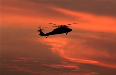 A U.S. military Black Hawk helicopter flies over the heavily fortified Green Zone in Baghdad, Iraq, Thursday, Dec. 21, 2006. A bomb killed an American soldier and two other U.S. Army servicemen died from combat injuries Thursday in Iraq. (AP