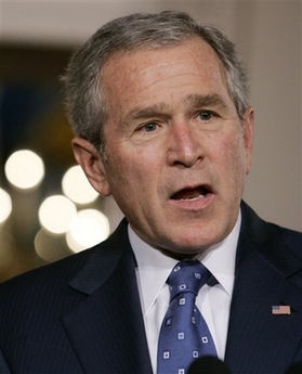 President Bush answers a reporter's question while making a joint statement with German Chancellor Angela Merkel, not pictured, in the Cross Hall of the White House in Washington Thursday, Jan. 4, 2007.