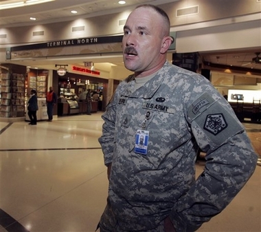 .S. Army staff sgt. James Woodford talks to a reporter after watching President Bush's address at Hartsfield Jackson Atlanta International Airport in Atlanta, Wednesday, Jan. 10, 2007. Woodford, who helps soldiers returning from Iraq through the airport, said he thinks a surge in troops size in Iraq is a good idea. (AP 