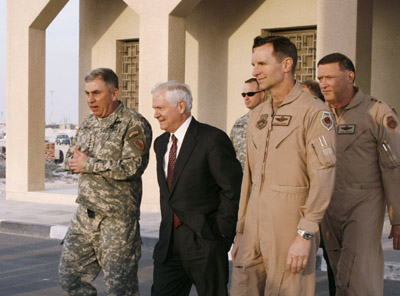 U.S. Army Gen. John Abizaid (L), head of the U.S. military's Central Command, talks with U.S. Secretary of Defense Robert Gates (2nd L) at a U.S. air base in the Gulf region January 18, 2007. U.S. officials allowed news media to cover the visit on the condition that the location of the base would not be named, citing host country sensitivity. 