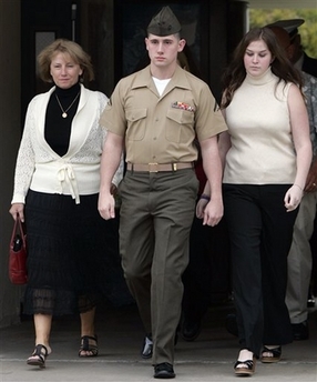 U.S. Marine Lance Cpl. Robert B. Pennington, center, walks to his court martial proceedings alongside his mother, Deanna Pennington, left, and girlfriend Krystal Morey, right, Tuesday, Feb. 13, 2007, at Camp Pendleton Marine Corps Base, Calif. Pennington is facing charges related to the death of 52-year-old Hashim Ibrahim Awad on April 26, 2006 in Hamdania, Iraq. (AP