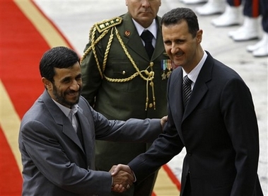 Syrian President Bashar Assad, right, shakes hands with his Iranian counterpart Mahmoud Ahmadinejad, during an official welcoming ceremony, in Tehran, Iran, Saturday, Feb. 17, 2007. (AP