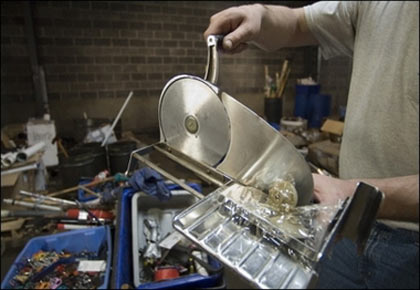 A worker holds a manual slicer at the Commonwealth Garage and Warehouse in Harrisburg, PA. The State Agency for Surplus Property (SASP) at the Harrisburg, Pennsylvania airport collects confiscated items like scissors, knives, lighters and the occasional machete from 12 different airports, including JFK and LaGuardia in New York, but also at Boston, Philadelphia and Syracuse, then sorts it, photographs it and puts up for sale on eBay as part of a program started in 2004 to raise new state revenues(AFP