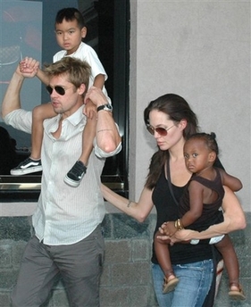 Angelina Jolie, right, with her daughter Zahara, and Brad Pitt, left, with Jolie's son Maddox, walk near the Gateway of India, unseen, in Mumbai, India, on Nov. 12, 2006.
