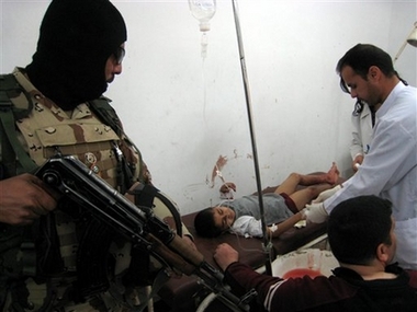 Medics help nine year old Shaheen Ahmed in Kirkuk, Iraq, 290 kilometers (180 miles) north of Baghdad, Tuesday, March 27, 2007.