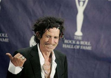 Rolling Stones guitarist Keith Richards gestures as he appears backstage during the 22nd annual Rock and Roll Hall of Fame induction ceremony at the Waldorf Astoria Hotel in New York, in this March 12, 2007 file picture.