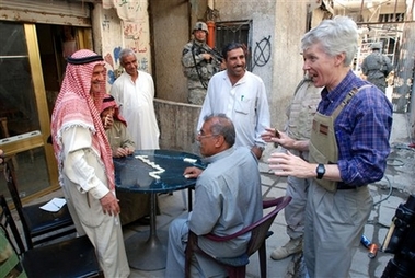 In this image released by the US Army on Wednesday April 11, Ryan Crocker, United States ambassador to Iraq, jokes with patrons of a market in Dora neighborhood in Baghdad, Iraq, Thursday, April 5, 2007.