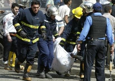 Firemen evacuate the body of a victim from the scene of a car bomb attack in Baghdad, April 15, 2007. 