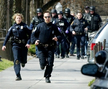 Blacksburg police officers run from Norris Hall on the Virginia Tech campus in Blacksburg, Va., Monday, April 16, 2007. 