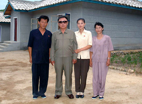 Kim Jong-il poses with farm manager