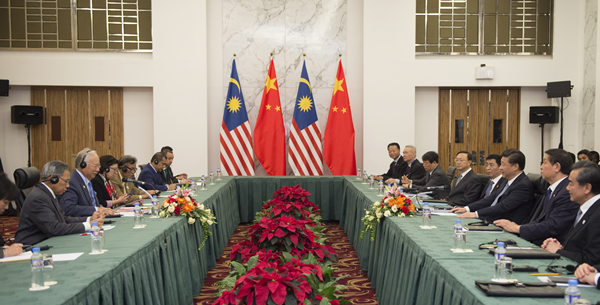 Xi pledges 'priority' to ties with Malaysia in China's neighborhood diplomacy