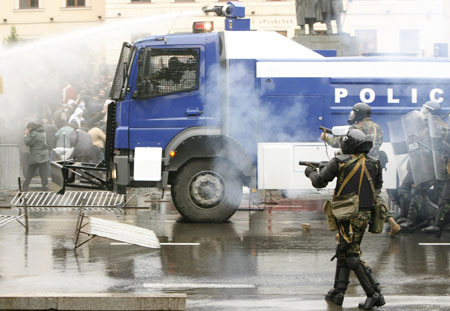 Police officers use a water cannon against opposition supporters during a rally in front of the parliament building in Tbilisi Nov. 7, 2007. 