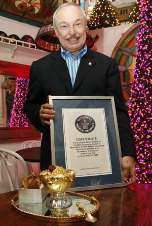 Stephen Bruce stands with a certificate next to the Frrrozen Haute Chocolate which was unveiled at his restaurant Serendipity-3 in New York Nov. 7, 2007 after Guinness World Records researchers determined the 25,000 U.S. dollars frozen hot chocolate was the most expensive dessert in the world.(Xinhua/Reuters Photo)