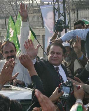 Pakistani opposition leader Nawaz Sharif waves to his supporters upon his arrival at Islamabad International Airport Islamabad December 3, 2007.