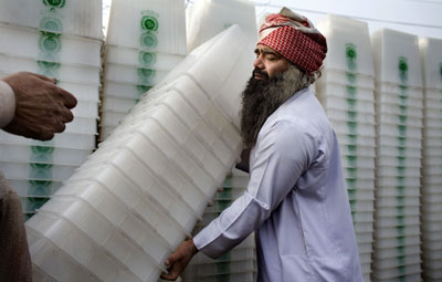 Workers load ballot boxes, which have to be delivered to election presiding offices in preparation for Monday's parliamentary elections, onto a truck in Lahore February 16, 2008. Suspected militants on Saturday blew up three polling stations in Pakistan's tribal region, local TV channel Geo reported. [Agencies]