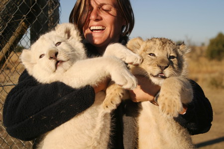 Woman lives with cheetahs, lion, wolves