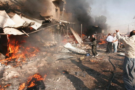 Iraqis celebrate US pullback but bombing kills 33