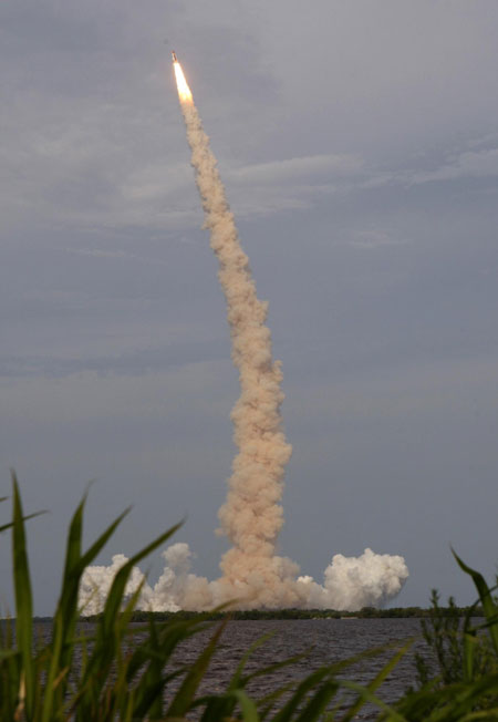 On sixth try, space shuttle lifts off