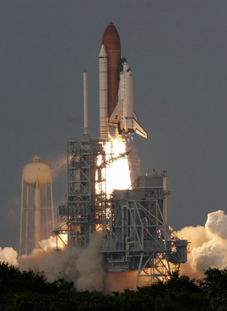 On sixth try, space shuttle lifts off