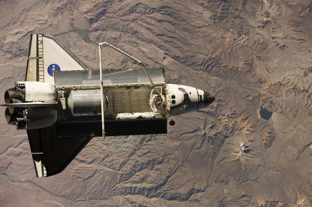 Space shuttle begins its journey home