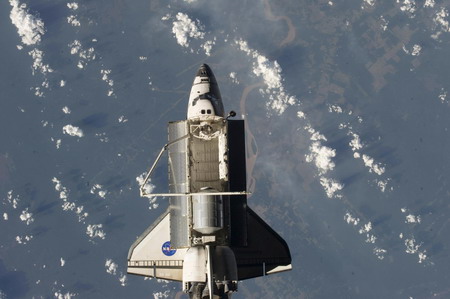 Space shuttle begins its journey home