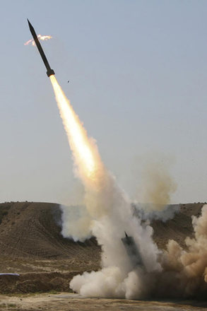 Under pressure for nukes, Iran test fires missiles