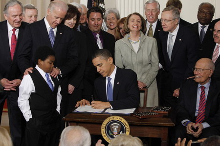 Obama signs historic healthcare overhaul