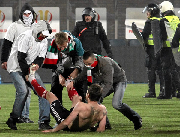 Polish hooligans undress player after match