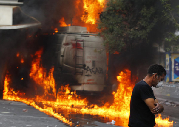 Greece passes steep cuts as riots seize capital