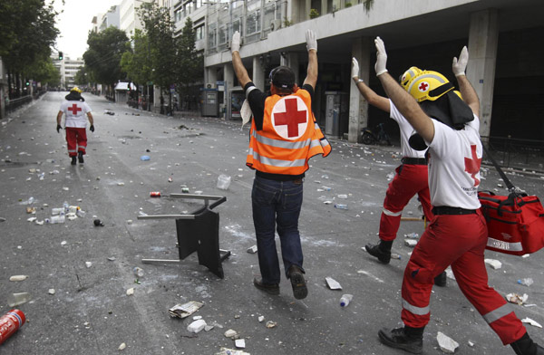 Greece passes steep cuts as riots seize capital