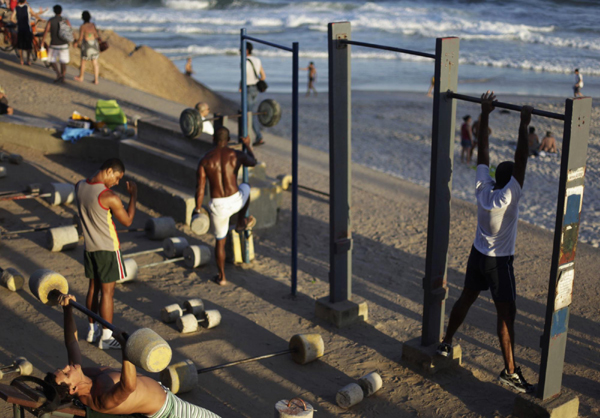 Men work out using cement-made weights