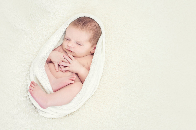 Sleeping newborns photographed in adorable poses