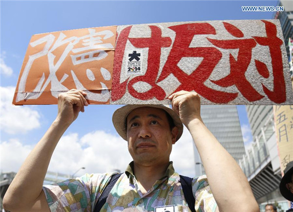 Abe's efforts to revise pacifist constitution encounter mass protest at home