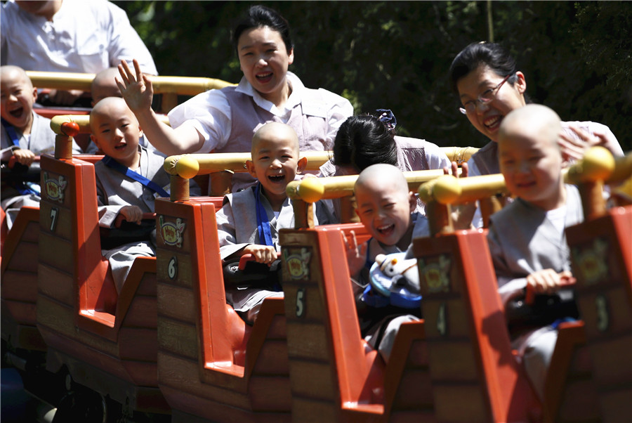 Young Buddhist monks ride on roller coaster in S. korea