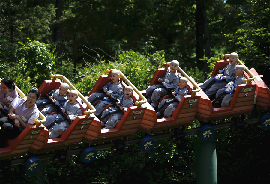 Young Buddhist monks ride on roller coaster in S. korea