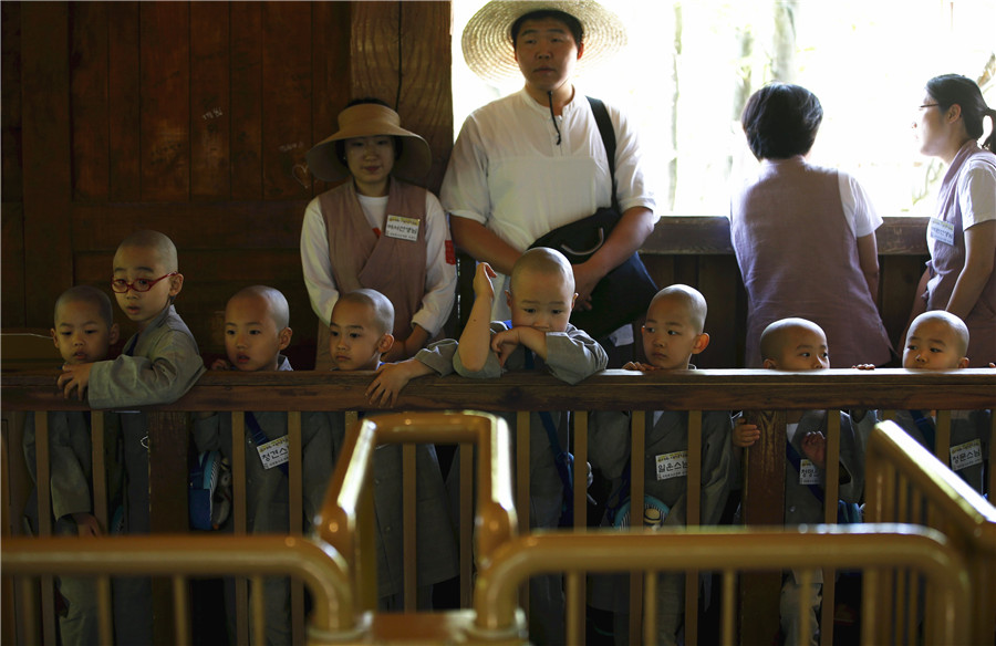 Young Buddhist monks ride on roller coaster in S. korea