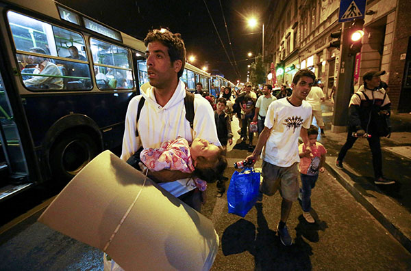 Migrants stream into Austria, swept west by overwhelmed Hungary