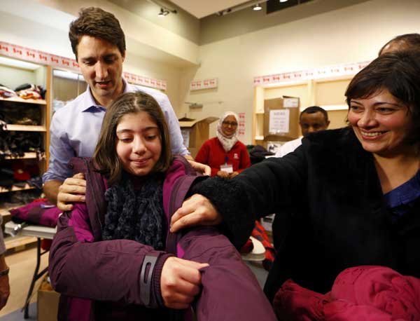 First planeload of Syrian refugees arrives in Canada