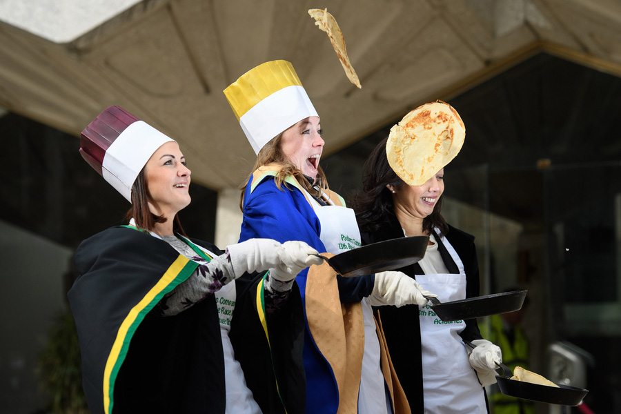 In costume, Londoners flip pancakes in annual race