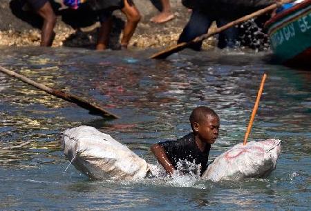 Haitians flee homeland by boat as in movie '2012'